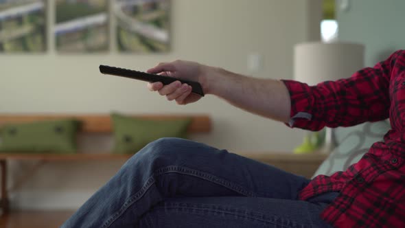 Low Angle Shot of a Man Switching Channels alt