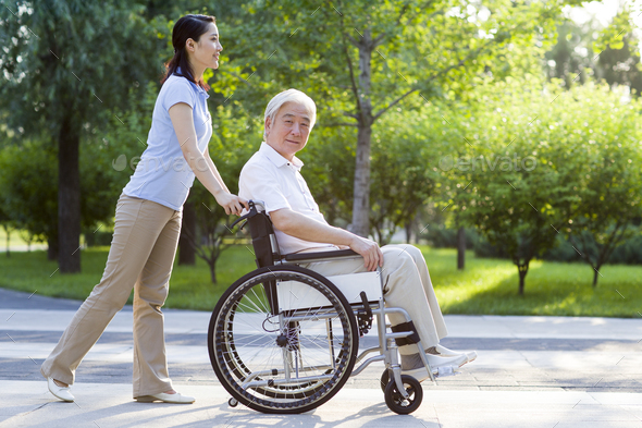 Wheelchair bound man with nursing assistant