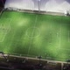Aerial view: Players players play soccer game at night on a green field. - VideoHive Item for Sale