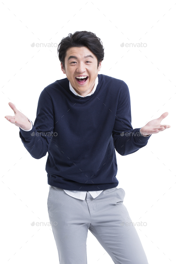 Humorous young man shrugging shoulders - Stock Photo - Images