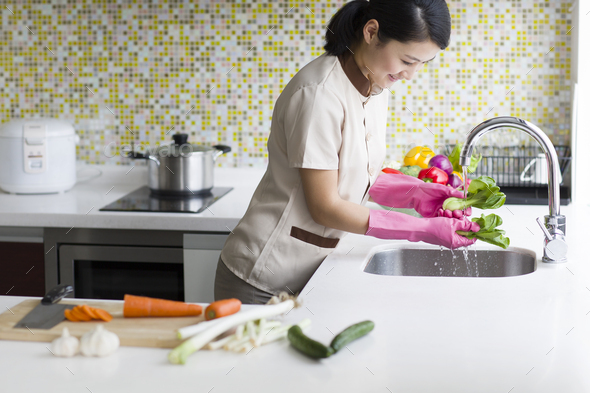 Domestic staff washing vegetables
