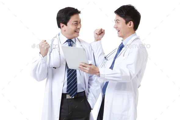 Male doctors punching the air with digital tablet in hand
