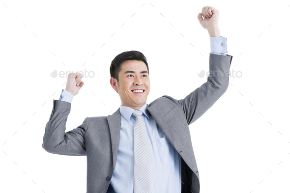 Excited businessman punching the air