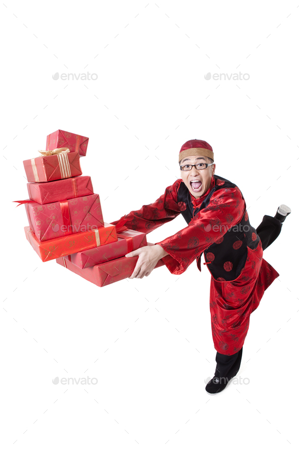 Excited young man in Tang suit running with gift boxes