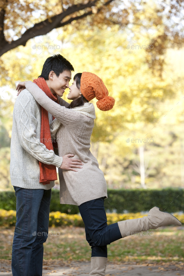 Young Couple Rubbing Noses in a Park in Autumn