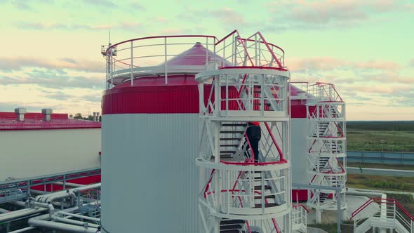 The Drone Hovers Over Oil Tanks alt