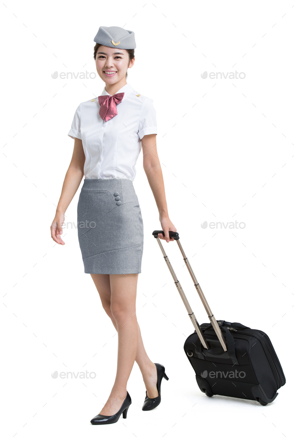 Smiling airline stewardess with wheeled luggage