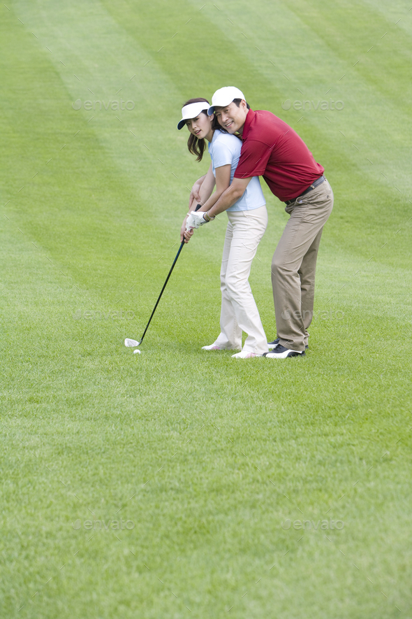 Golf coach teaching playing golf