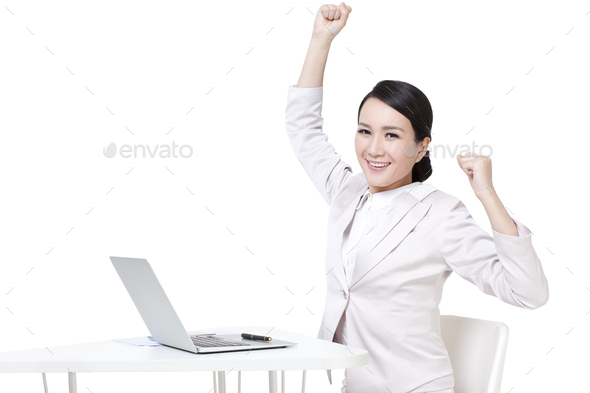 Excited businesswoman punching the air