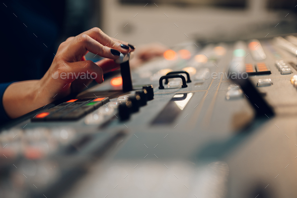 Woman hands using equipment in control room on a tv station