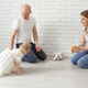 Baby child with hearing aids and cochlear implants plays with parents on floor - PhotoDune Item for Sale