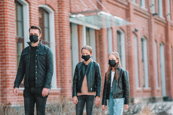 People wearing a mask on a background of a modern building