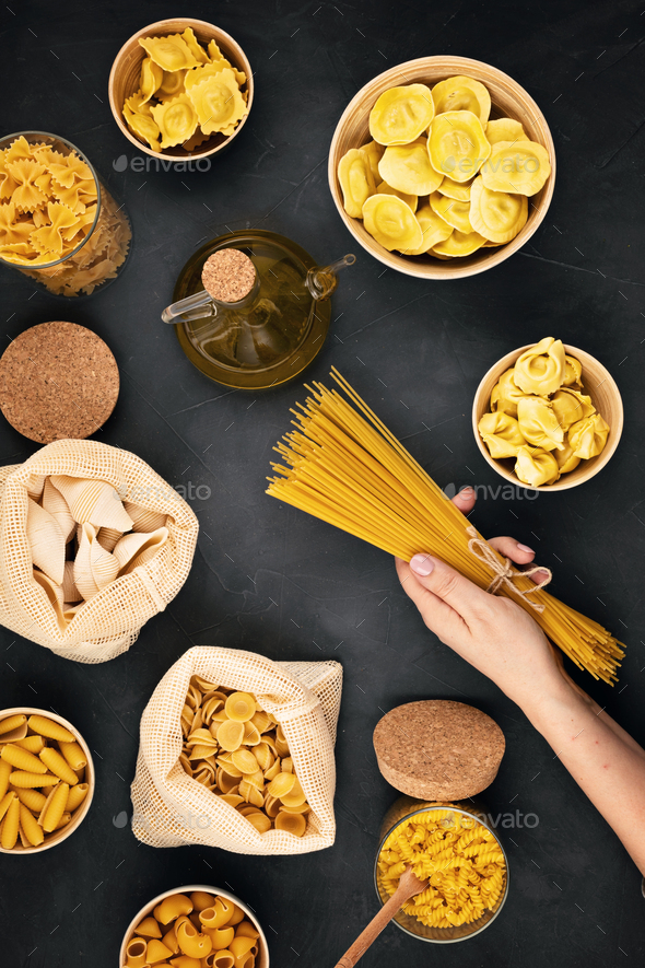 Flat lay with tradiotional organic italian pasta and cooking ingredients in reusable cotton bags and