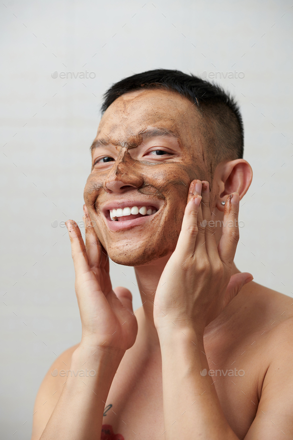 Man Applying Face Scrub
