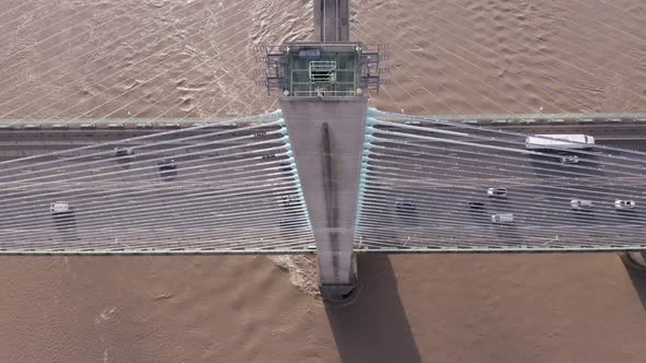 Cars and Lorries Driving Across a Cable Stayed Bridge Aerial View alt
