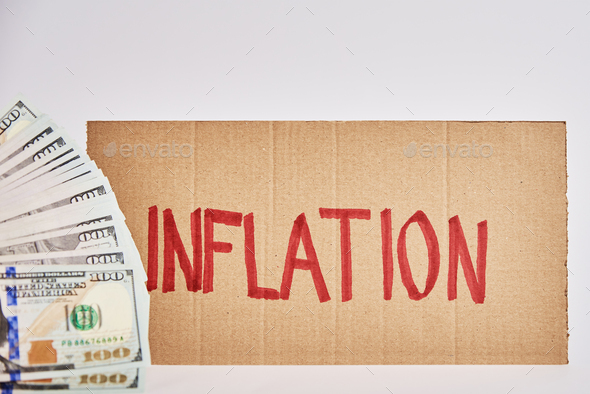 World inflation concept. Cardboard with word inflation and usd banknotes - Stock Photo - Images