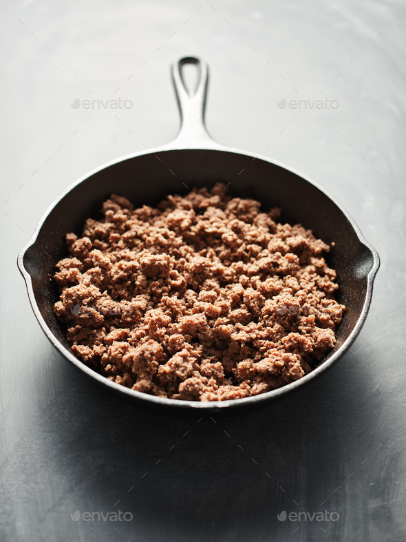 browned ground beef in cast iron skillet Stock Photo by joshua_resnick