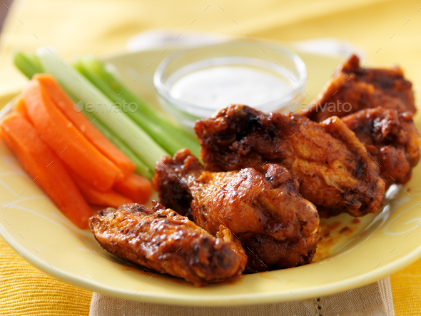 platter of bbq chicken wings, celery and carrot sticks, with ranch dip