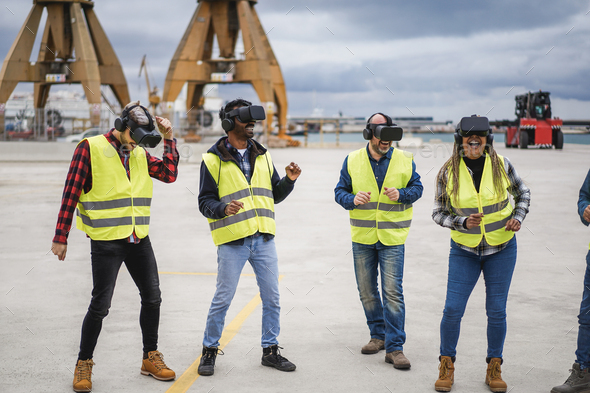 Multiracial workers dancing to music using virtual reality headsets at Freight Terminal Port - Stock Photo - Images