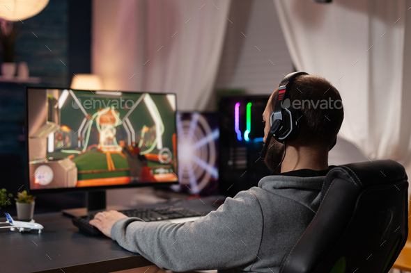 Free Photo  Adult using keyboard and mousepad to play video games on  computer. gamer playing online game in front of monitor with control  console and mouse on desk. modern player with
