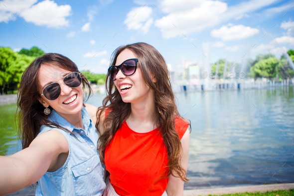 Caucasian girls making selfie background big fountain. Young tourist ...