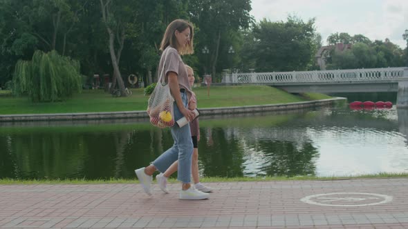 Woman walks in the city with her daughter