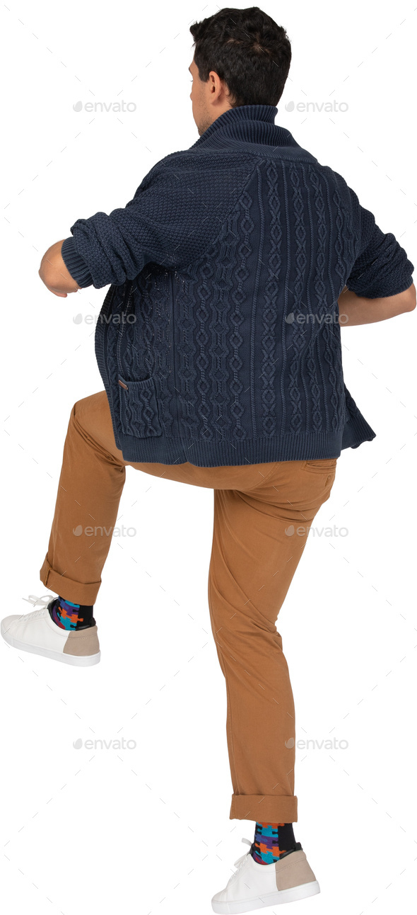 Fashion look of woman dressed red pants, blue jacket, brown bag over grey  background. model looks at a leather bag Stock Photo - Alamy