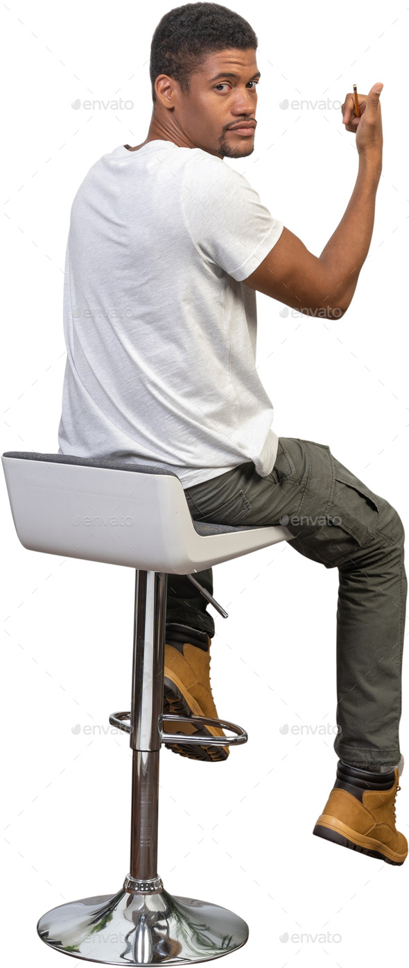 a man sitting on a chair with his foot on a stool