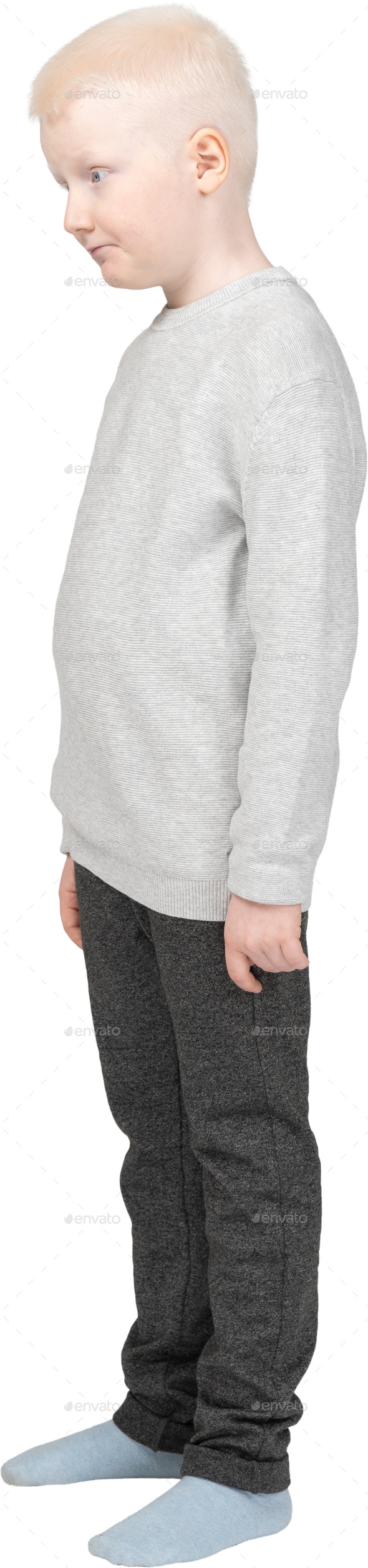 a young boy wearing a gray sweatshirt and gray pants