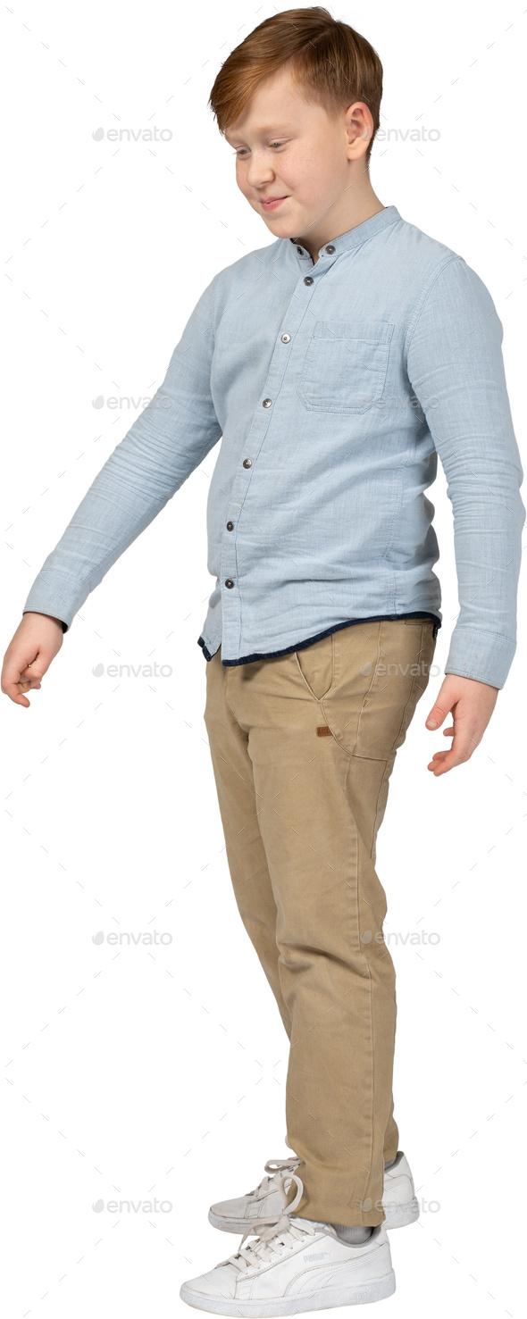 a young boy wearing a blue shirt and khaki pants Stock Photo by Icons8