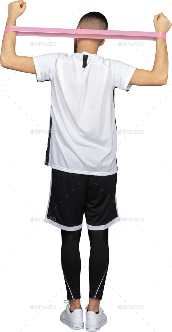 a man in a white shirt and black shorts holding a resistance band on his head