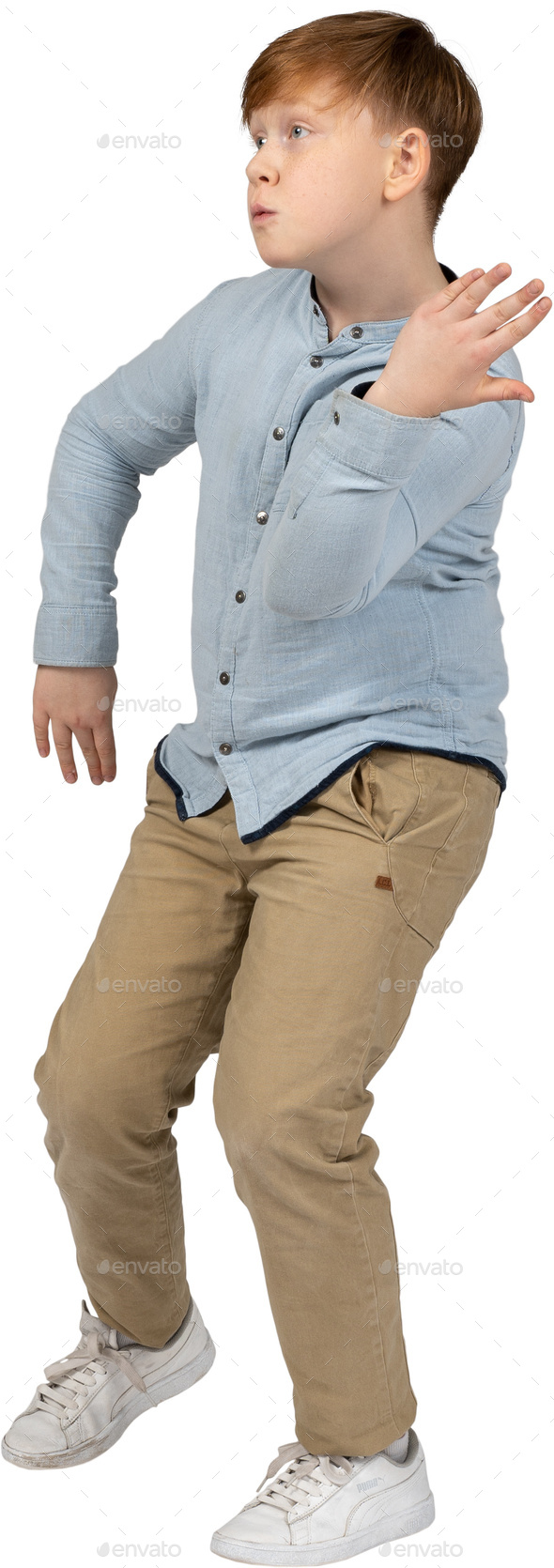 a young boy wearing a blue shirt and khaki pants Stock Photo by Icons8