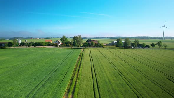 Countryside Village with Wind Turbine, Low Aerial Drone View, Slide Right alt
