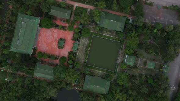 aerial top down rotation of ancient Buddhist temple and gardens in south Vietnam alt