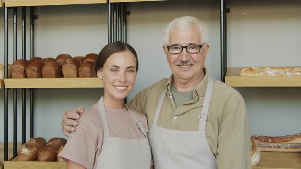 Young and Elderly Bakery Employees Posing alt