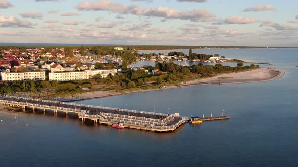 Flying over the pier in Jastarnia on Hel peninsula at the Baltic Sea in Poland alt