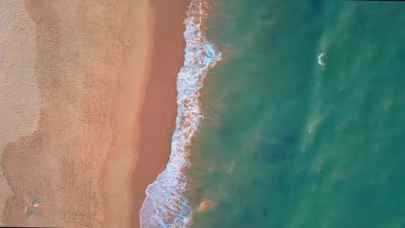 Drone flight over empty Gale beach in Portugal with top view on shoreline  alt