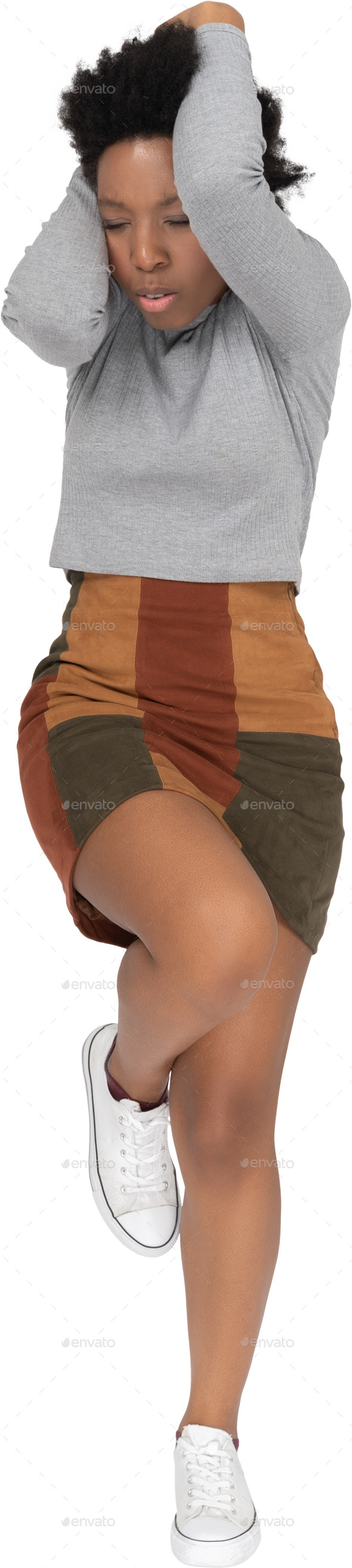 a woman jumping in the air with her legs crossed Stock Photo by Icons8