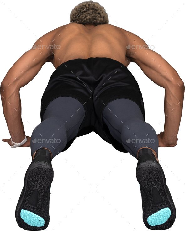 a man in black shorts and blue compression socks crouches on the floor