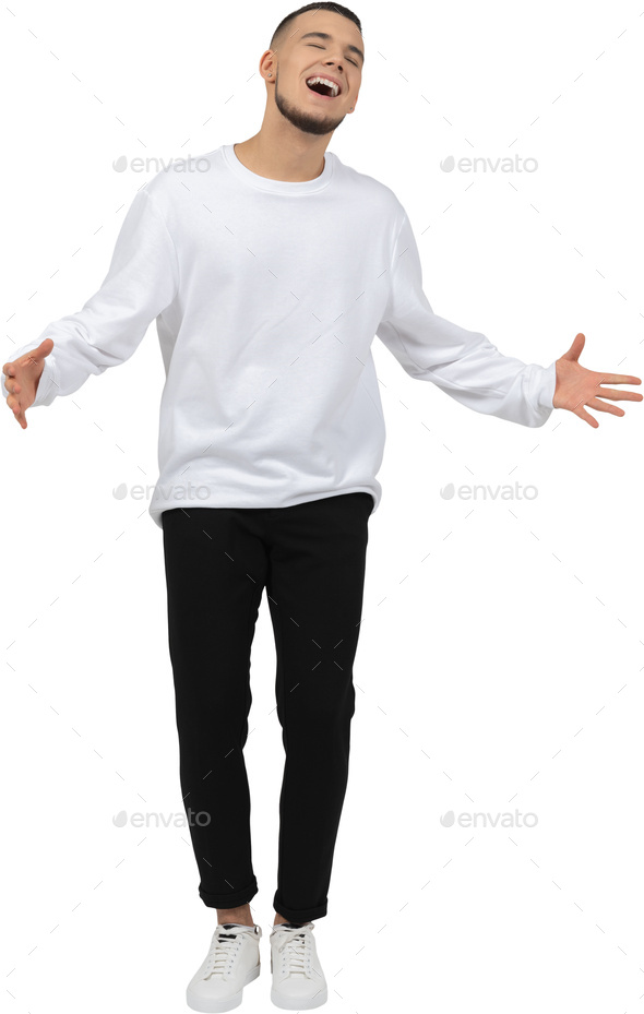 a man in a white sweatshirt and black pants is standing with his arms out