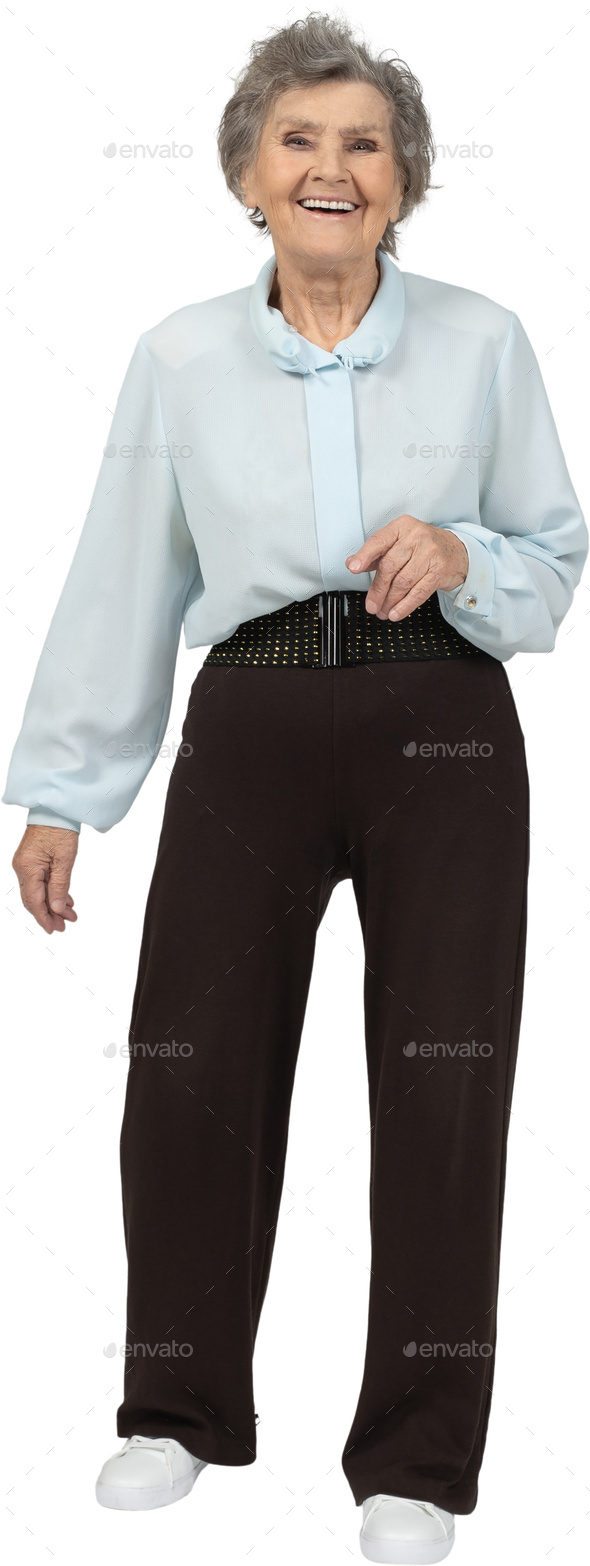 an older woman wearing a blue shirt and brown pants Stock Photo by Icons8