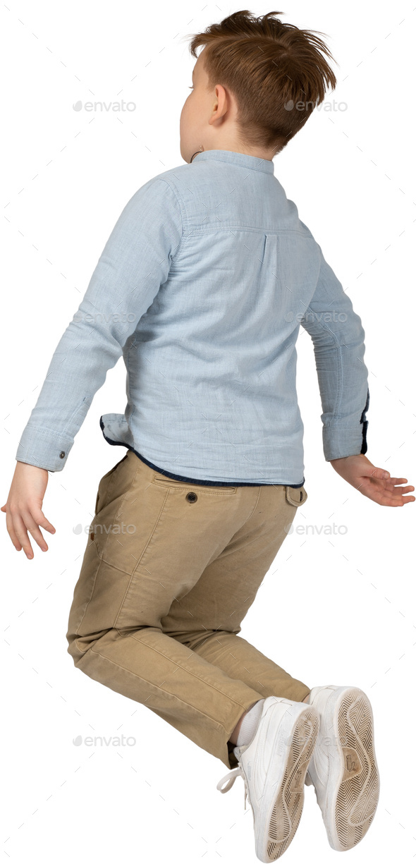 a young boy jumping in the air with his arms outstretched Stock Photo ...