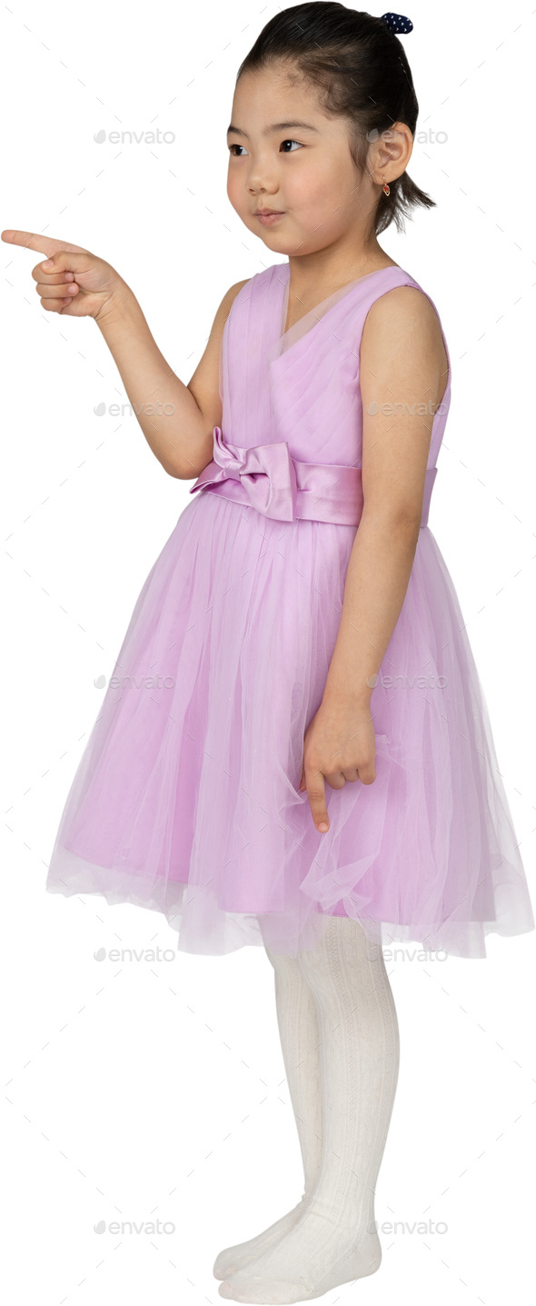 a little girl wearing a pink dress and white tights Stock Photo by