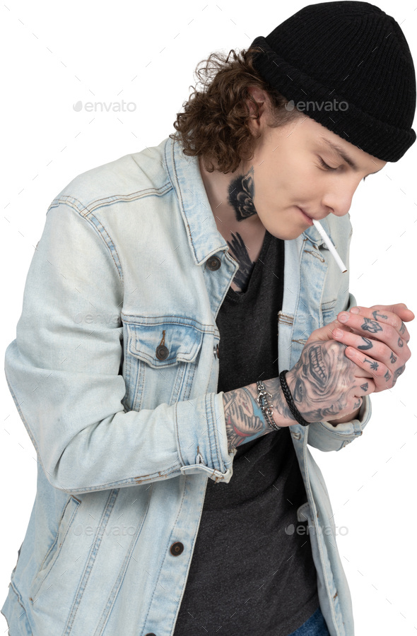 a woman smoking a cigarette and wearing a denim jacket