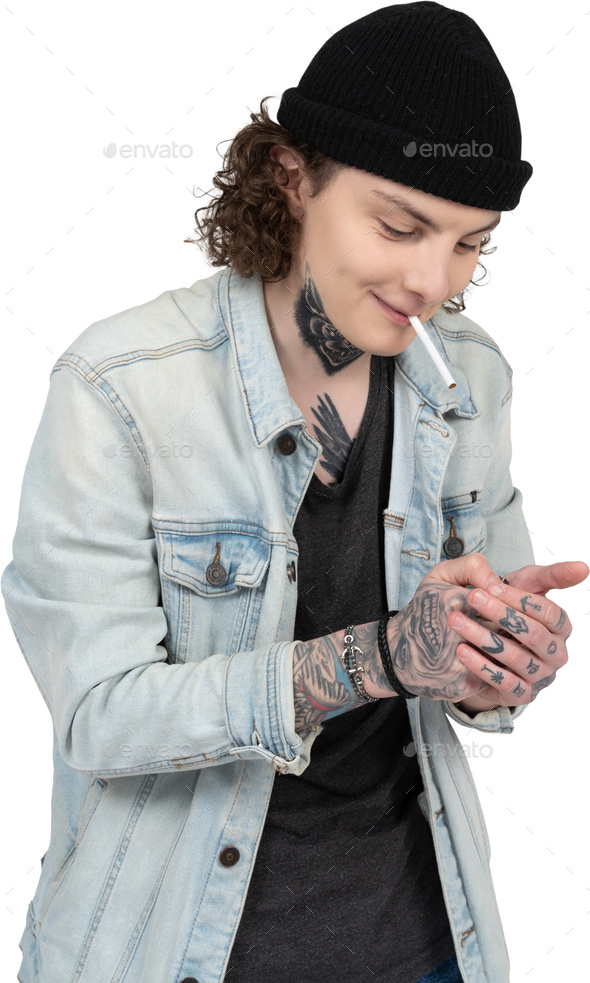 a woman smoking a cigarette while wearing a denim jacket
