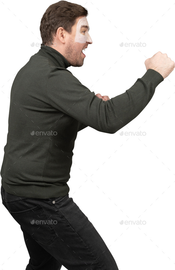 a man in a black shirt and black jeans with his fists in the air