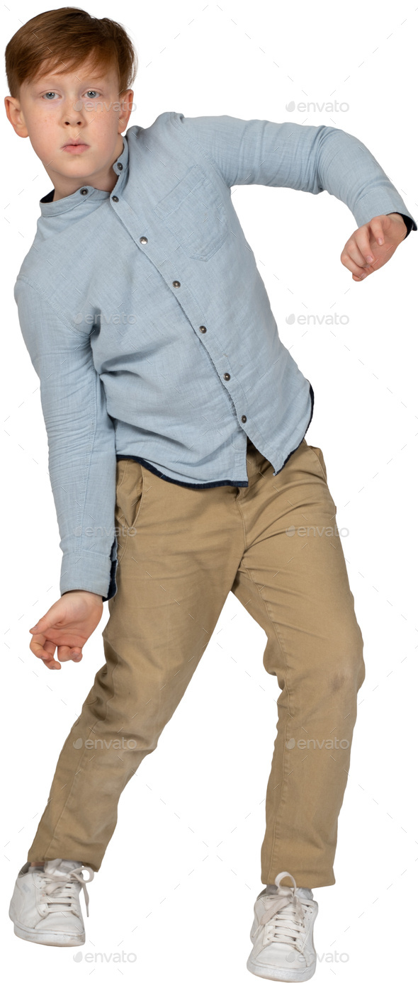 a young boy in a blue shirt and khaki pants Stock Photo by Icons8 ...