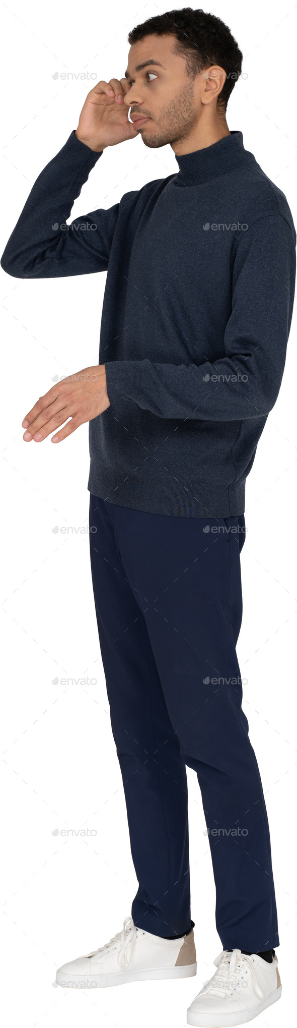 a man in a navy sweatshirt and black pants with his hand on his face