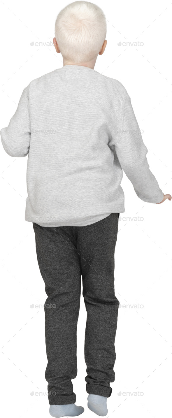 a young boy wearing a white sweatshirt and gray pants