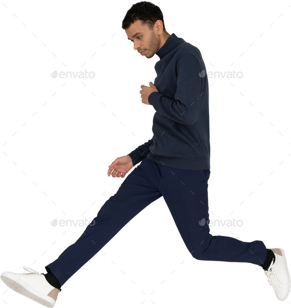 a man in a blue sweatshirt and navy pants is running